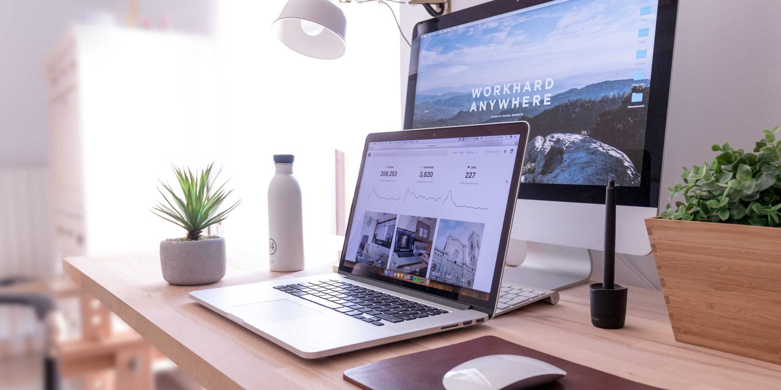 5-Mistakes-Companies-Are-Making-in-the-Digital-Workplace-scaled.jpg MacBook Pro on table beside white iMac and Magic Mouse