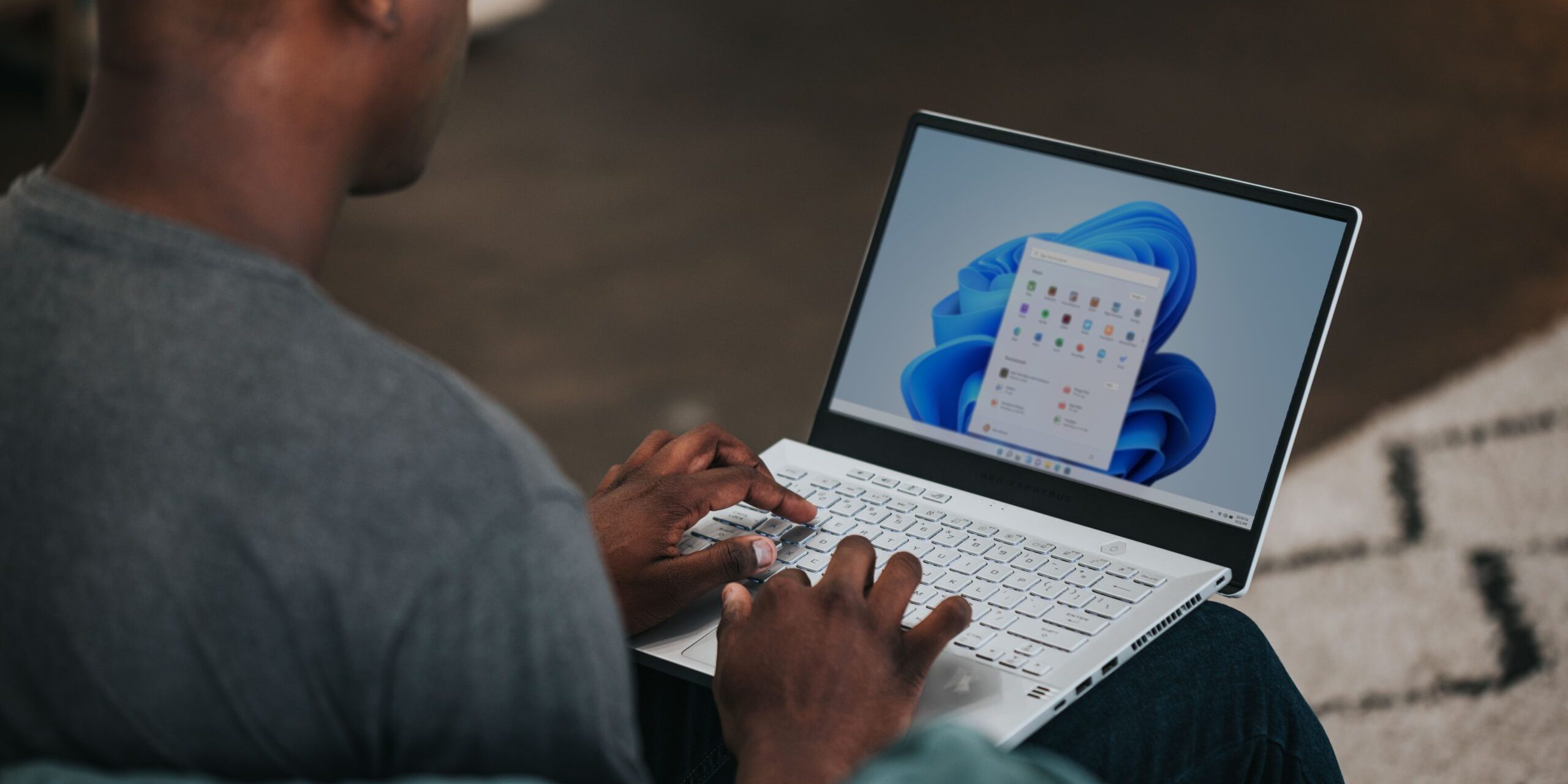 How-to-Create-Insightful-Dashboards-in-Microsoft-Power-BI-Featured-Image-scaled.jpg man in gray long sleeve shirt using Windows 11 computer