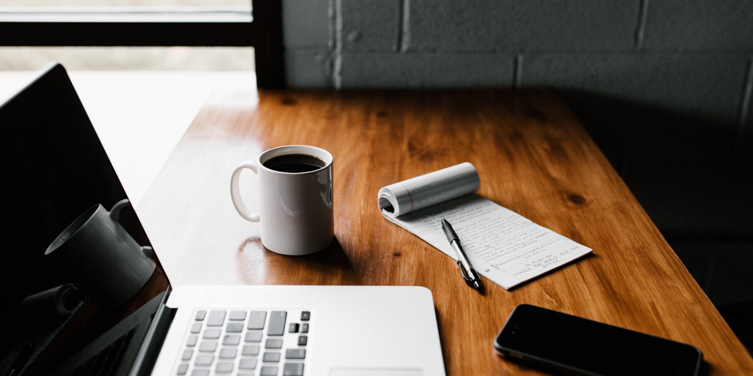 Handy-Checklist-for-Handling-Technology-Safely-During-a-Home-or-Office-Move-scaled.jpg MacBook Pro, white ceramic mug,and black smartphone on table