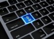 a computer keyboard with a blue light on it